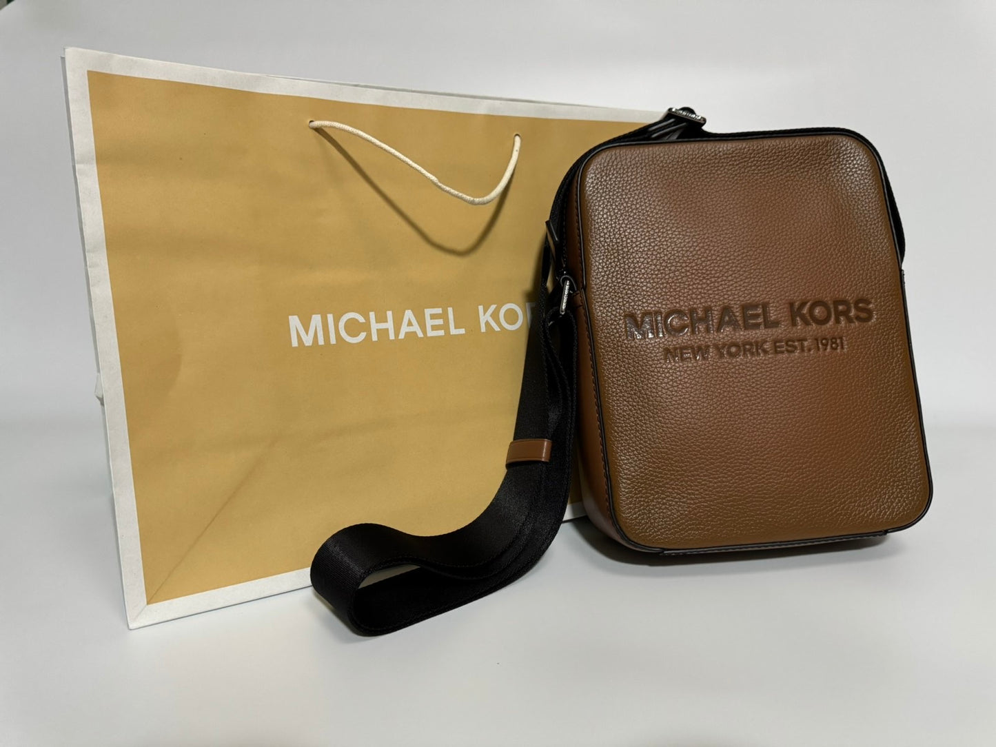 Michael Kors Cooper Logo Embossed Pebbled Leather Flight Bag (Brown)