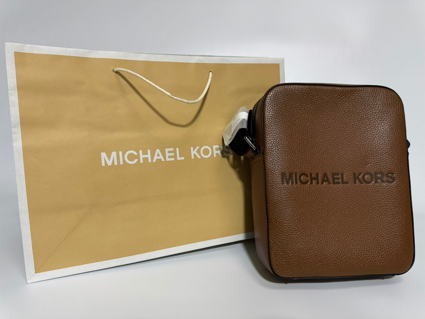 Michael Kors Cooper Logo Embossed Pebbled Leather Messenger Bag (Brown)